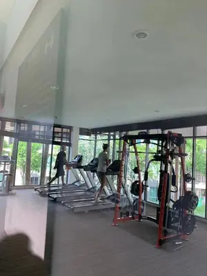 a group of people walking on treadmills in a gym at Cozy and delightful room with pool view in Kathu