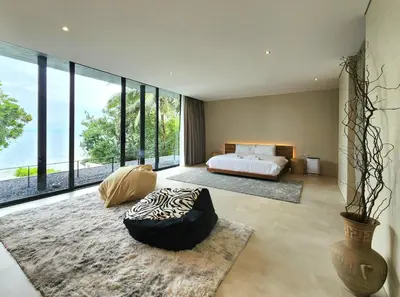 a bedroom with a bed and a large window at Luxury Beachfront AMANA Villa 4 Br at Ta-Ke Residence A in Phuket Town