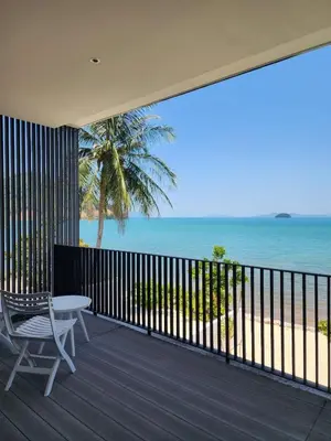 a balcony with a table and a view of the ocean at Luxury Beachfront AMANA Villa 4 Br at Ta-Ke Residence A in Phuket Town