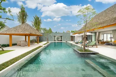 an infinity pool in the backyard of a villa at Spacious Mansion 4BR Villa Anchan V20 with 15m Private Pool in Gated Residence in Bang Tao Beach