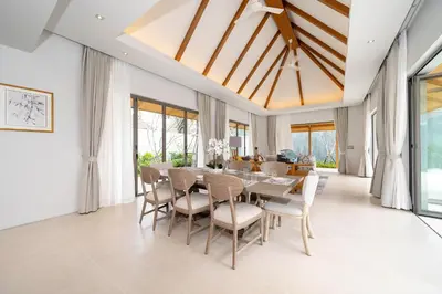 a dining room with a table and chairs at Spacious Mansion 4BR Villa Anchan V20 with 15m Private Pool in Gated Residence in Bang Tao Beach
