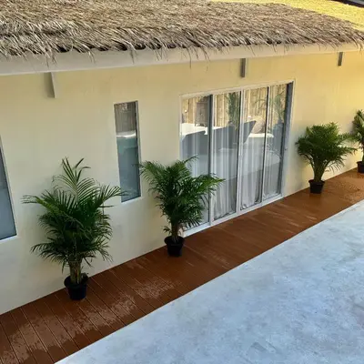a patio with potted plants on a house at L’Oasis Nanai in Patong Beach