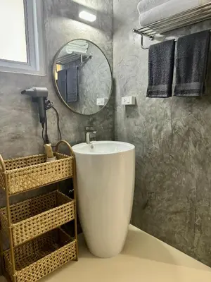 a bathroom with a large tub and a mirror at L’Oasis Nanai in Patong Beach
