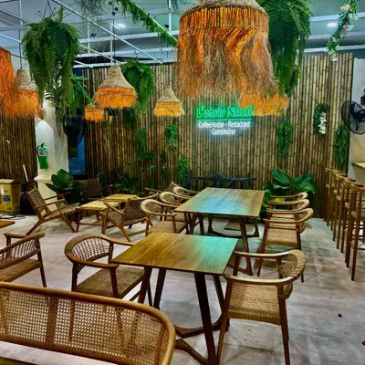 a restaurant with tables and chairs and a sign at L’Oasis Nanai in Patong Beach