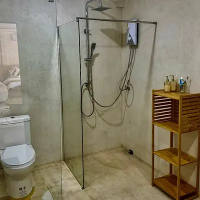 a bathroom with a shower and a toilet at L’Oasis Nanai in Patong Beach