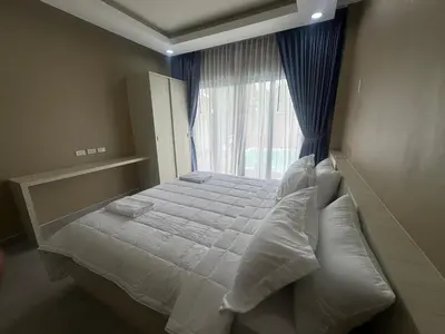 a bedroom with a large bed with a window at Luxury Boutique Pool Villa Ao Nang Krabi in Ao Nam Mao