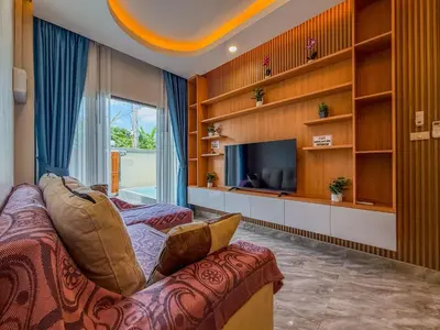 a living room with a couch and a tv at Luxury Boutique Pool Villa Ao Nang Krabi in Ao Nam Mao