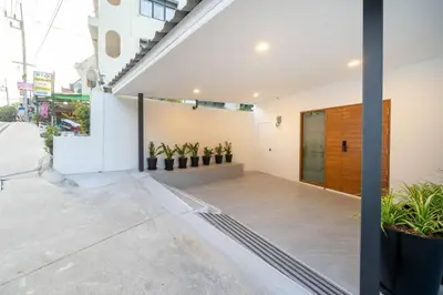 a facade of a building with a door and plants at 2BR townhome 300M walk to kata beach Fully equipped in Kata Beach