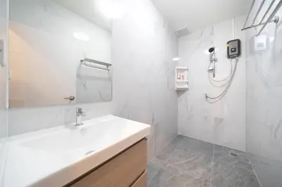 a white bathroom with a sink and a shower at 2BR townhome 300M walk to kata beach Fully equipped in Kata Beach