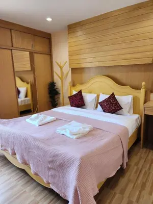 a hotel room with two beds with towels on them at Alaita Hostel Patong in Patong Beach