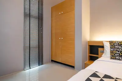 a bedroom with a bed and a closet at Serene Wallaya Villa Harmony in Ban Pak Lak