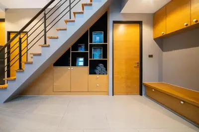 a hallway with a staircase and a wooden door at Serene Wallaya Villa Harmony in Ban Pak Lak