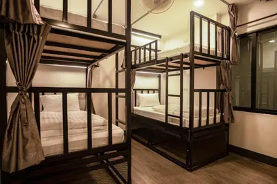 two bunk beds in a room with wooden floors at Sea Beach Hostel & Club Beachfront 18-39 years only in Ao Nang Beach