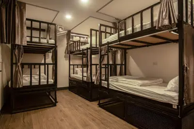 a room with four bunk beds in a room at Sea Beach Hostel & Club Beachfront 18-39 years only in Ao Nang Beach