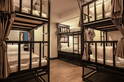 a room with four bunk beds and a mirror at Sea Beach Hostel & Club Beachfront 18-39 years only in Ao Nang Beach