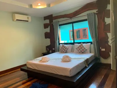 a bedroom with a large bed in a room at Baan Pongam Resort in Ao Nang Beach