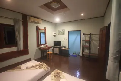 a living room with a couch and a table and a mirror at Baan Pongam Resort in Ao Nang Beach