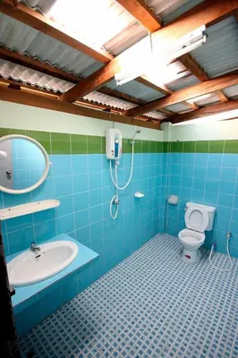 a bathroom with a toilet and a sink and a mirror at Baan Pongam Resort in Ao Nang Beach