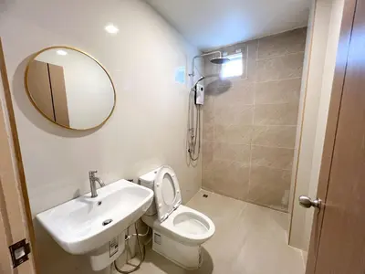a bathroom with a sink and a toilet and a mirror at 48 House in Patong Beach