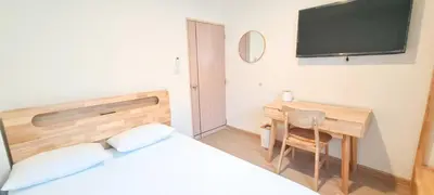 a bedroom with a bed and a desk and a tv at 48 House in Patong Beach