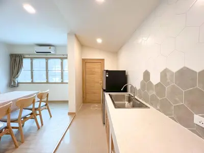 a kitchen with a sink and a table with chairs at 48 House in Patong Beach
