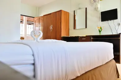 a bedroom with a bed with two swans on it at Heimat Garden - Your Home in Koh Yao Yai in Ban Lo Pa Ret