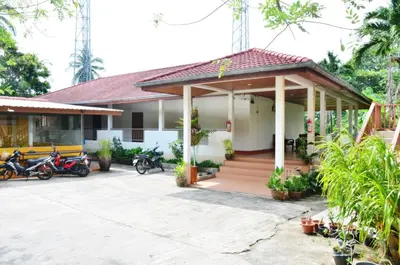 a house with motorcycles parked in front of it at Heimat Garden - Your Home in Koh Yao Yai in Ban Lo Pa Ret