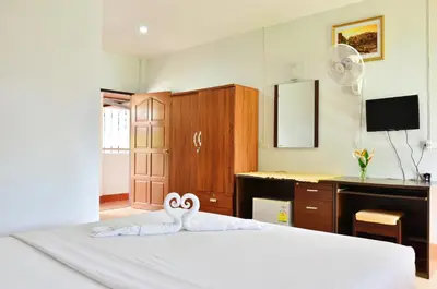 a bedroom with a bed with two swans on it at Heimat Garden - Your Home in Koh Yao Yai in Ban Lo Pa Ret