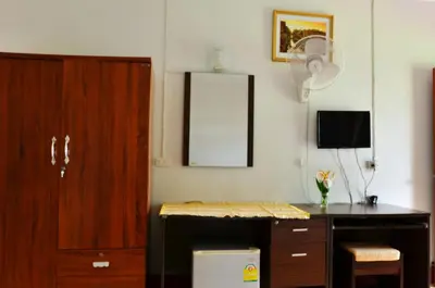 a room with a desk and a cabinet and a mirror at Heimat Garden - Your Home in Koh Yao Yai in Ban Lo Pa Ret