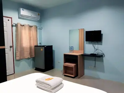 a blue room with a bed and a tv and a room with a bed gmaxwell at Heimat Garden - Your Home in Koh Yao Yai in Ban Lo Pa Ret