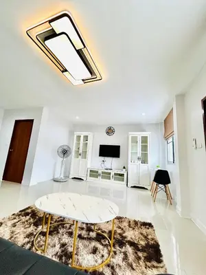 a living room with a table and a tv at Vibe Phuket Private Rooms in Shared Villa Some Shared Bathrooms in Phuket Town