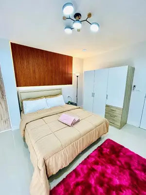 a bedroom with a large bed with a pink rug at Vibe Phuket Private Rooms in Shared Villa Some Shared Bathrooms in Phuket Town