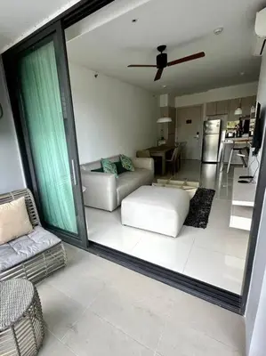 a living room with a couch and a ceiling fan at Квартира Cassia Residences Lake View in Bang Tao Beach