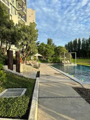 a swimming pool in a building next to a building at Квартира Cassia Residences Lake View in Bang Tao Beach