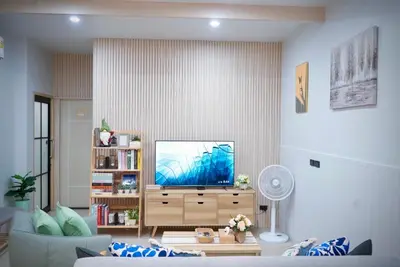 a living room with a tv on a dresser at Room61-รูม61 in Phuket Town