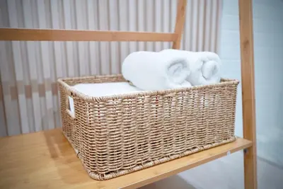 a wicker basket sitting on a chair with towels at Room61-รูม61 in Phuket Town