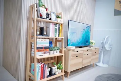 a book shelf with a television on top of it at Room61-รูม61 in Phuket Town