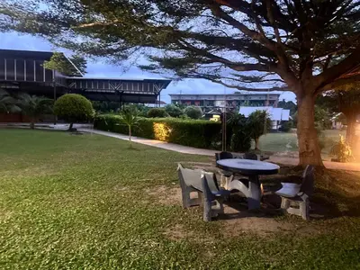a picnic table and chairs under a tree in a park at Gypsy Sea View Resort- Phi Phi Island in Phi Phi Don