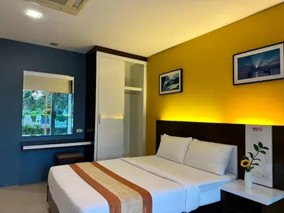 a bedroom with a bed and a yellow wall at Gypsy Sea View Resort- Phi Phi Island in Phi Phi Don