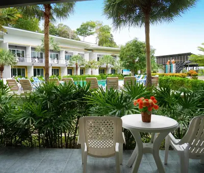 a patio with a table and chairs and a pool at Gypsy Sea View Resort- Phi Phi Island in Phi Phi Don