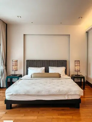a bedroom with a large bed with two lamps at Pearl of Naithon 3 bedrooms in Nai Thon Beach