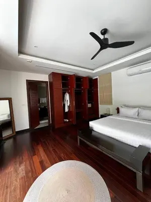 a bedroom with a bed and a ceiling fan at The Residence Resort in Phuket Town