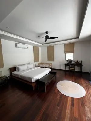 a bedroom with a bed and a ceiling fan at The Residence Resort in Phuket Town