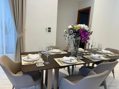 a dining table with chairs and a vase of flowers at Luxury Breeze Villa with private pool & maid in Bang Tao Beach