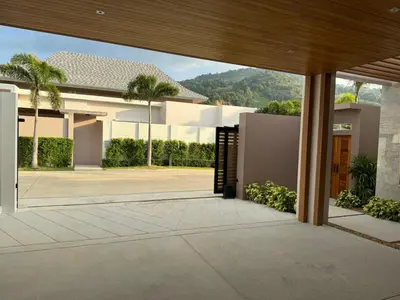 a house with a view of a courtyard at Luxury Breeze Villa with private pool & maid in Bang Tao Beach