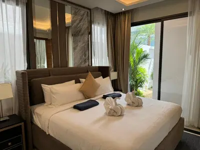 a bedroom with a large bed with towels on it at Luxury Breeze Villa with private pool & maid in Bang Tao Beach