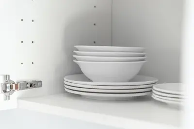 a stack of white bowls and plates on a counter at Great Hill Tropic View Pool Gym Naiyang in Nai Yang Beach