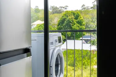 a washing machine in a room with a balcony at Great Hill Tropic View Pool Gym Naiyang in Nai Yang Beach