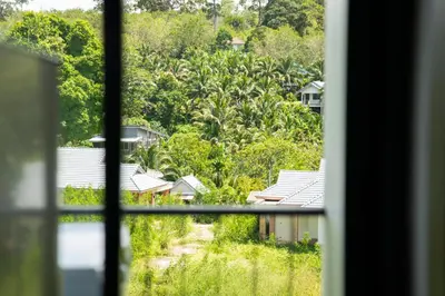 a view of a village from a window at Great Hill Tropic View Pool Gym Naiyang in Nai Yang Beach