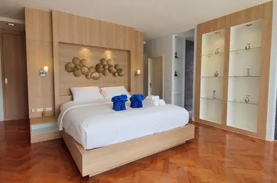 a bedroom with two blue teddy bears on a bed at Stylish penthouse with panoramic views at Icon Park in Kamala Beach